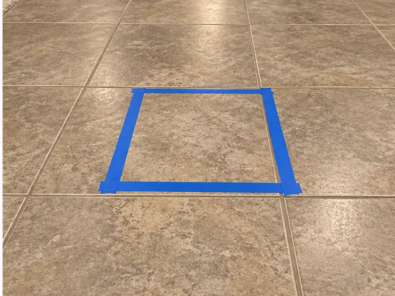 Acoustic pinpoint mark on slab floor allowing single-tile spot repair access